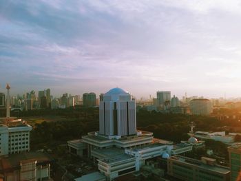 High angle view of cityscape against cloudy sky