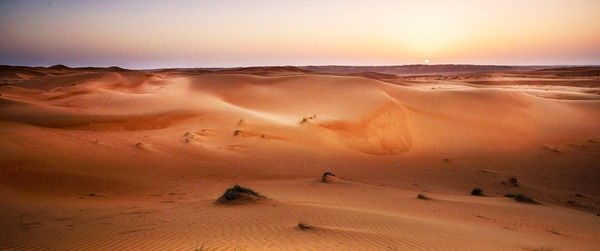 Scenic view of desert against sky during sunset