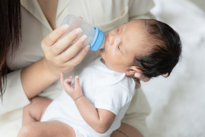 Midsection of mother holding baby