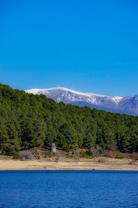 Scenic view of mountains against blue sky