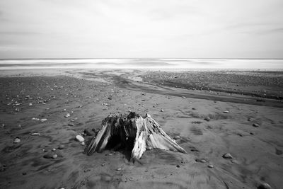 Long exposure beach art photo with old words falling on the sand, black and white photo