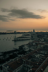 High angle view of buildings in city at sunset