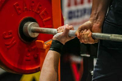 Midsection of man exercising in gym