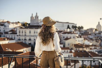 Man looking at city buildings