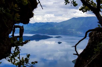 Scenic view of lake against cloudy sky