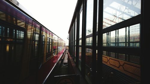 Railroad tracks in city against clear sky