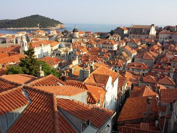 High angle view of town by sea against sky