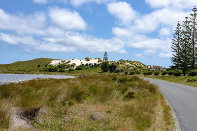 Scenic view of road by land against sky