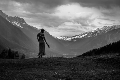 Man standing on mountain road against sky