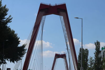 Low angle view of suspension bridge against sky