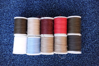 Close-up of colorful thread spool on fabric
