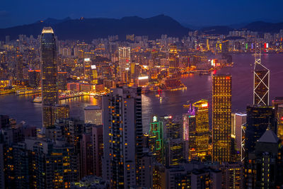 Illuminated cityscape against sky at night