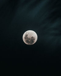 Low angle view of moon against sky at night