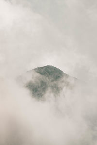 Scenic view of mountain against cloudy sky