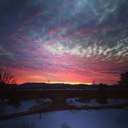 Scenic view of snow covered landscape at sunset