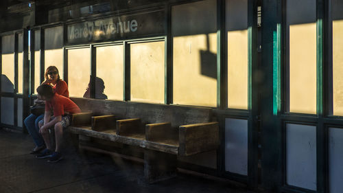 Full length of woman standing on bench