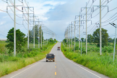 Cars on road against sky