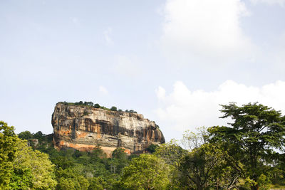 Low angle view of cliff against sky