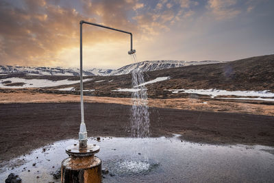 View of hot spring shower from geothermal power at krafla during sunset