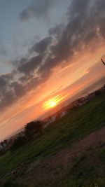 Scenic view of field against sky during sunset