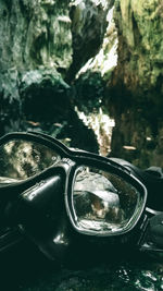 Close-up of sunglasses on side-view mirror