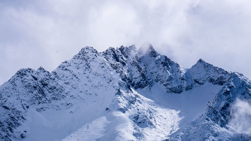 Scenic view of snow covered mountains against sky