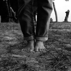 Low section of person standing on field