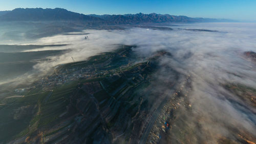 Aerial view of volcanic mountain against sky