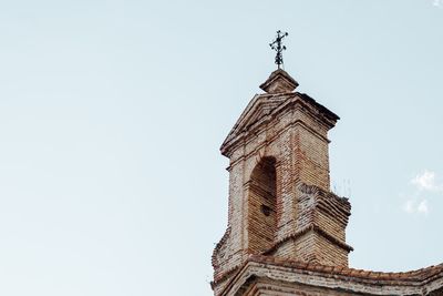 Low angle view of bell tower against sky