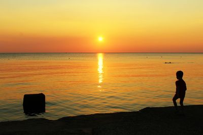 Scenic view of sea against orange sky