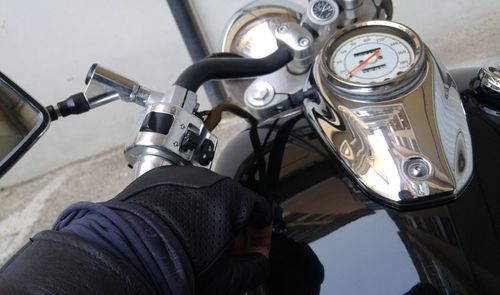 Cropped hand of man on motorcycle