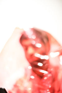 Close-up of illuminated light over white background