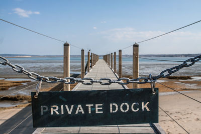 Private dock text hanging on chain at pier