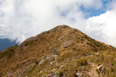 Rear view of man on mountain against sky