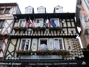 Low angle view of potted plants on balcony of building