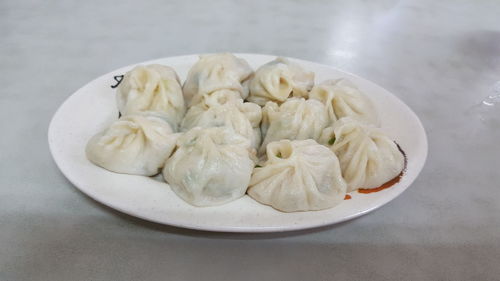 Chinese dumplings in plate on table