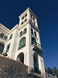 Low angle view of historic building against clear blue sky