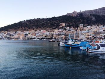 Boats in river with town in background