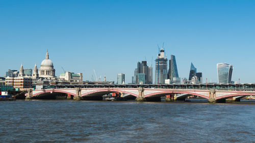 Bridge over river with buildings in background