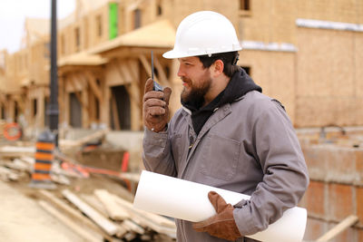 Side view of young man working at construction site