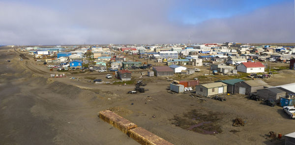 High angle view of buildings by sea against sky