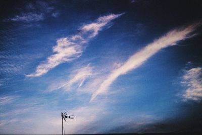 Low angle view of silhouette telephone against sky during sunset