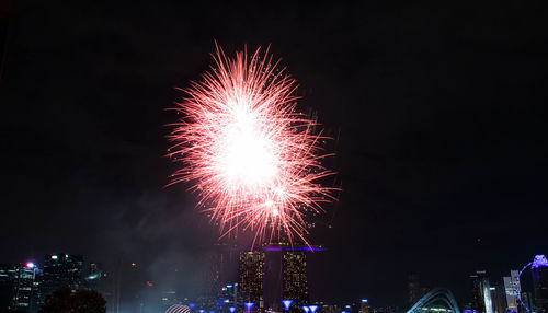 Low angle view of firework display at night