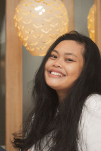 Close-up of young woman smiling on camera 