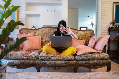 Woman uses her laptop to make a video call