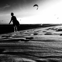 Full length of woman jumping at beach