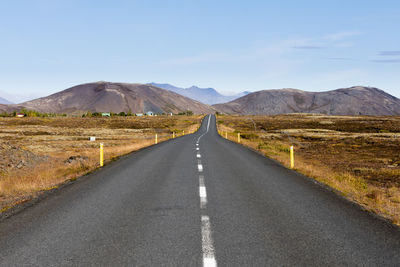 Empty road along countryside landscape