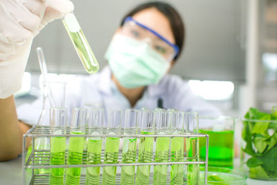 Portrait of woman experimenting chemical in laboratory