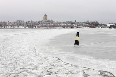 View of snow covered city against clear sky
