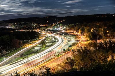 High angle view of light trails on road at night